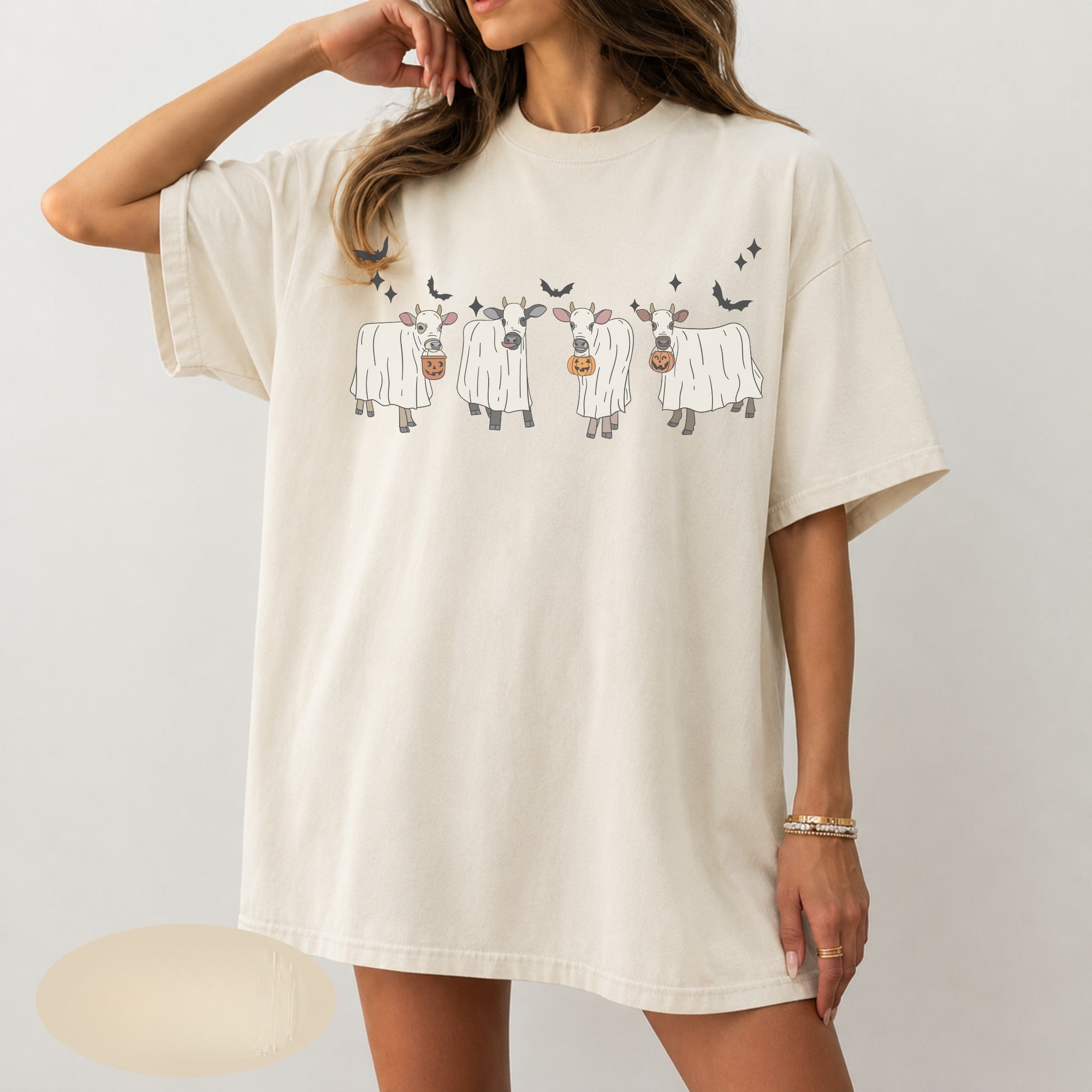 Four cows in ghost sheets with pumpkin buckets DTF transfer on ivory t-shirt