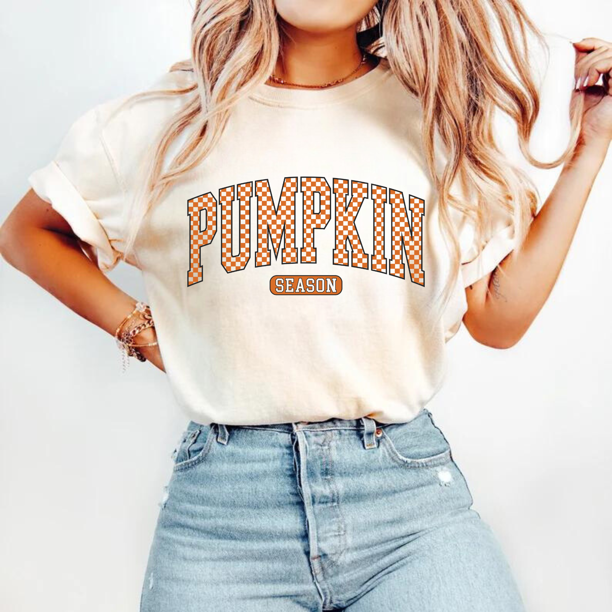 Pumpkin Season checkered varsity DTF transfer on a cream t-shirt