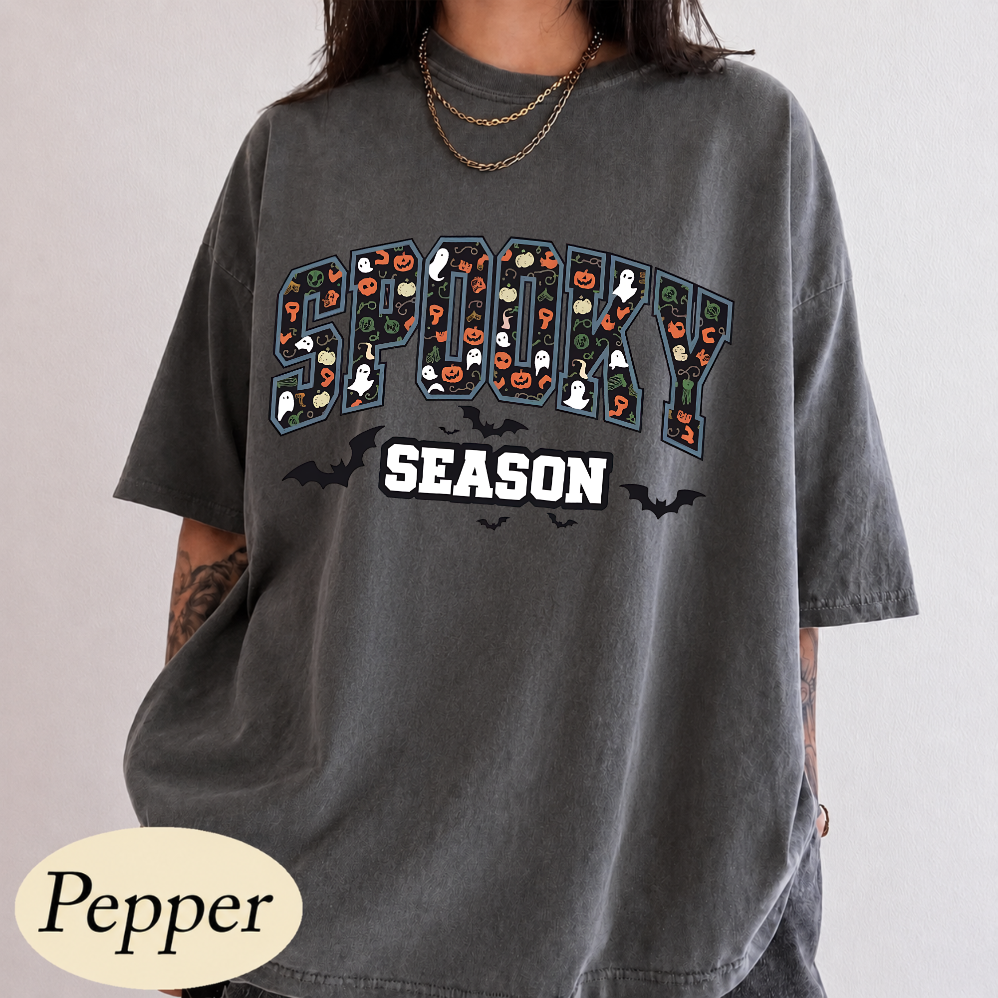 Spooky Season varsity arch lettering with Halloween icons and bats DTF transfer on pepper grey Comfort Colors t-shirt