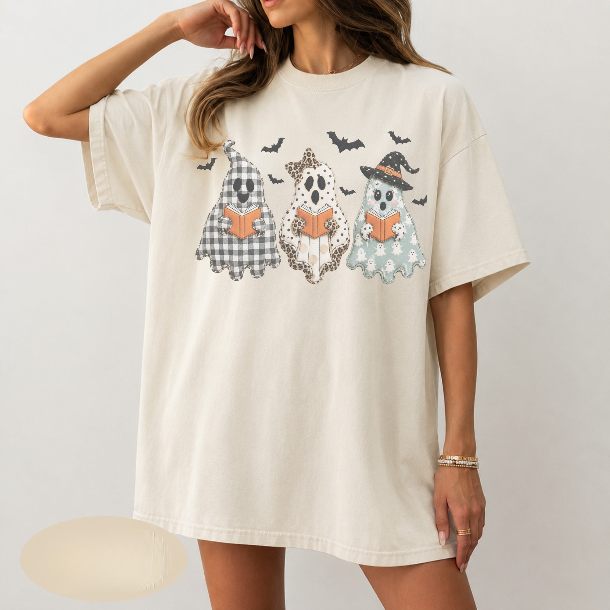 Three ghosts reading books with bats DTF transfer on ivory t-shirt