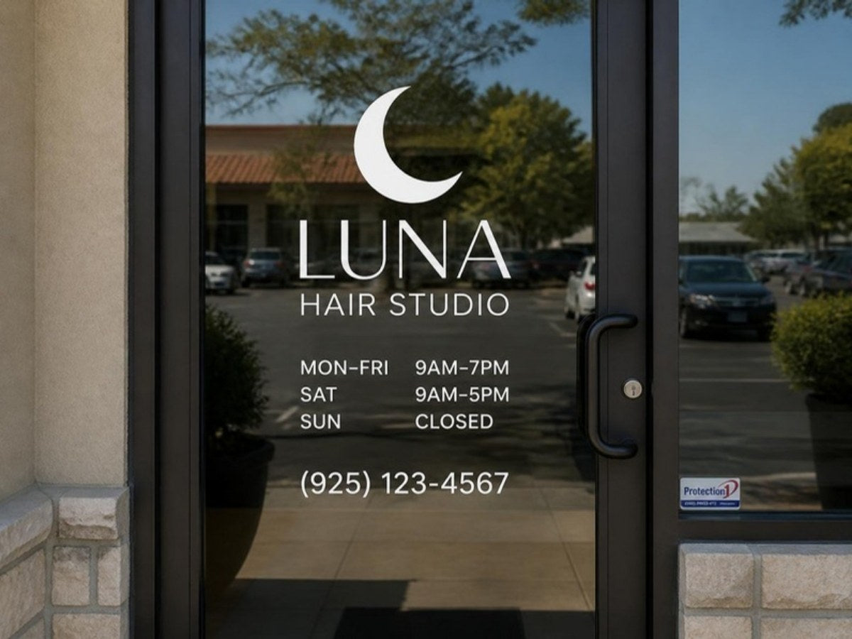 Logo and store hours vinyl decal set on a glass storefront door