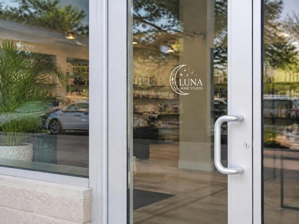 Small logo decal next to the handle of a glass door