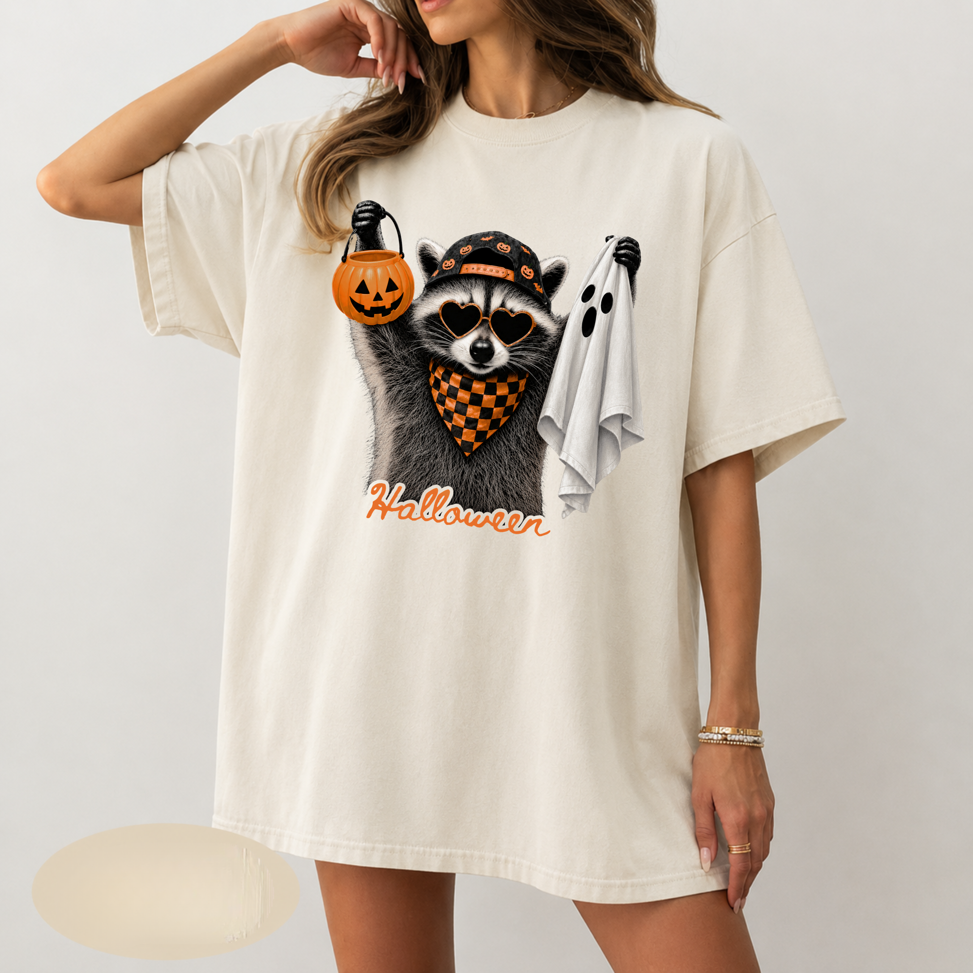 Halloween raccoon with pumpkin bucket and ghost DTF transfer pressed on ivory Comfort Colors t-shirt