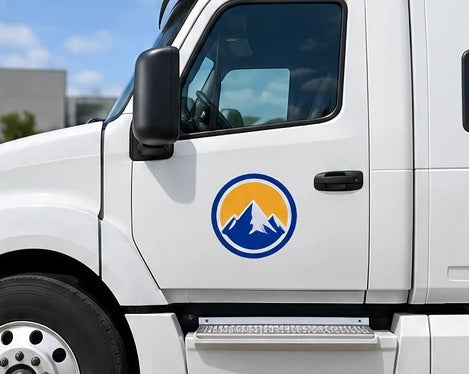 Full-color printed logo decal on a white truck door