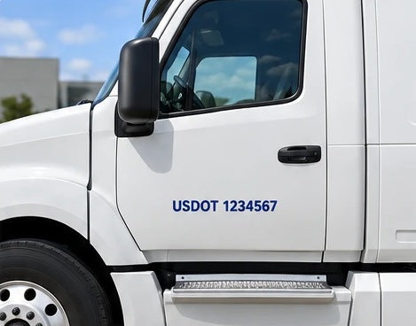 USDOT number cut in black vinyl on a white truck door